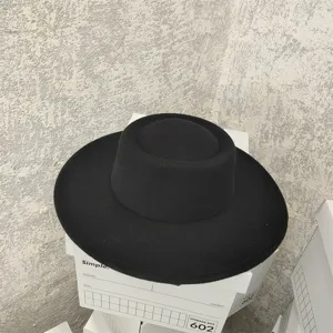 Black flat top wool felt hat detail, wide brim vintage winter hat close up view