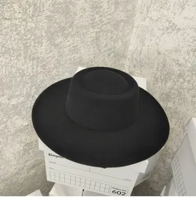 Detailed view of a classic black wool flat top hat with wide brim, vintage retro style.