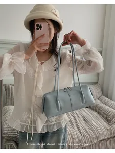 Light blue vintage bowling shoulder bag for women, stylish pillow handbag for daily commute.