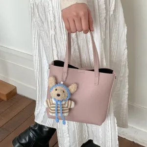 Chic pink women bucket bag with cute knit bear pendant, stylish commuter tote handbag main view