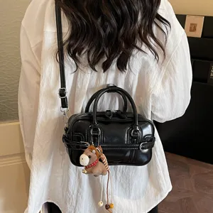 Korean style black glossy shoulder bag for women, chic crossbody tote with cute horse pendant.