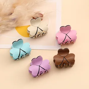 Detail view of cute heart shaped hair claw clips in multi colors for women daily styling.