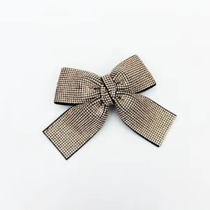 Sparkling rhinestone bow hair clip detail close-up, elegant crystal hairpin for women and girls.