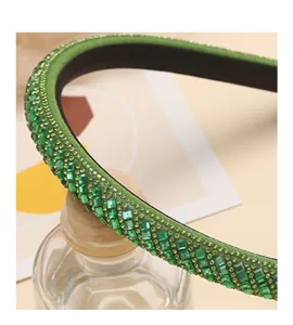 Detail view of a stunning green rhinestone crystal headband, sparkling hair accessory for women.