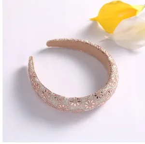 Gros plan détaillé d'un serre-tête tournesol en cristal strass scintillant finition or rose.