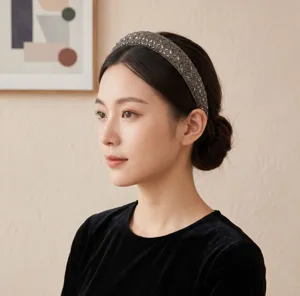 Close up view of luxury rhinestone headband worn by model, sparkling crystal hair accessory.