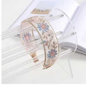 Elegant wide embroidered headband with delicate floral sequins and sheer mesh fabric design.