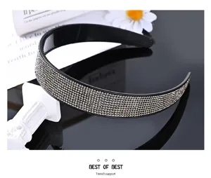 Detail shot of the wide rhinestone headband, sparkling crystal encrusted surface, elegant design.