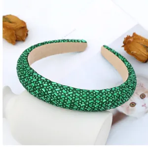 Green crystal rhinestone padded headband detail shot showing exquisite glittering crystal craft.