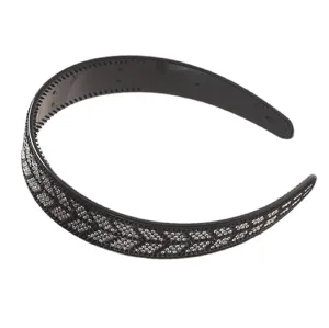Detailed view of black rhinestone headband with fishbone pattern, elegant hair accessory.