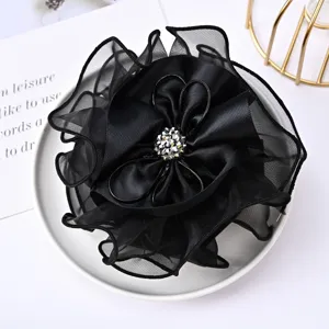 Elegant black chiffon satin flower hair accessory with sparkling rhinestone center for women.