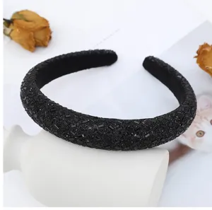 Detailed view of a luxury black rhinestone headband, sparkling crystal hair accessory for women.