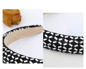 Glittering crystal rhinestone padded headband detail, stylish black crystal hair hoop.