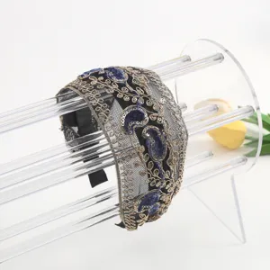 Elegant embroidered mesh headband with gold metallic threads and blue velvet sequins.