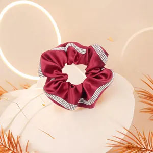 Close-up shot of the stunning rhinestone-trimmed satin hair scrunchie, rich texture.