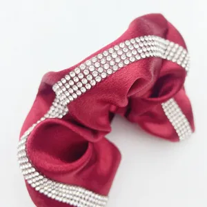 Red satin hair scrunchie with sparkling rhinestone details for elegant daily hairstyles.