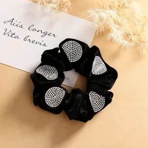 Black velvet hair scrunchie with sparkling rhinestones, elegant hair accessory for women.