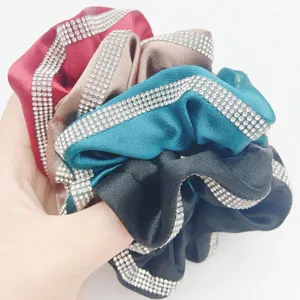 Detailed view of fashionable satin hair scrunchies with sparkling rhinestone borders for women.