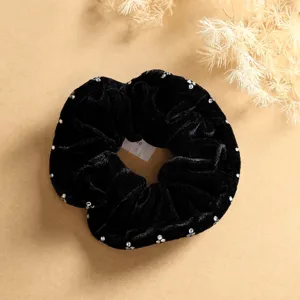 Black velvet hair scrunchie with sparkling rhinestones, premium hair accessory detail shot.