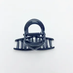 Matte black hair claw clip detail, small size for thin hair, secure grip fashion accessory.