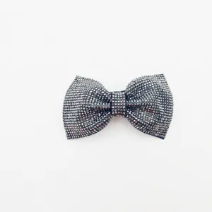 Close-up detail of the sparkling rhinestone bow hair clip, elegant grey design measuring 9cm.