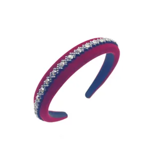 Close up view of the elegant red velvet headband adorned with sparkling rhinestones.