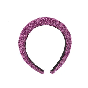 Detail view of the purple pebbled texture padded headband, stylish high crown hair hoop.