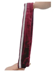 Detailed close up of burgundy velvet hair scrunchie with rhinestone strip and soft texture.