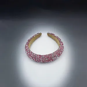 Close-up detail of a sparkly pink rhinestone padded headband with crystal embellishments.