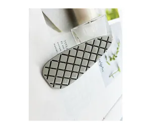 Detailed shot of the stylish metallic grid hair clip with delicate rhinestone embellishments.