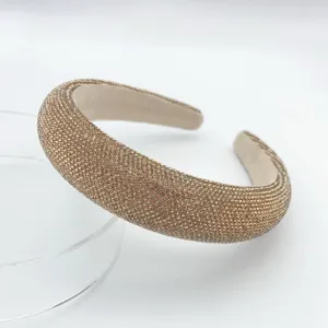 Sparkling rhinestone padded headband detail, luxury crystal hair hoop, close-up view.