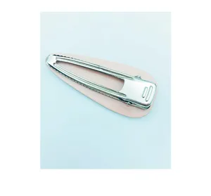 Detailed close-up of a stylish pink teardrop snap hair clip with a silver metal base.