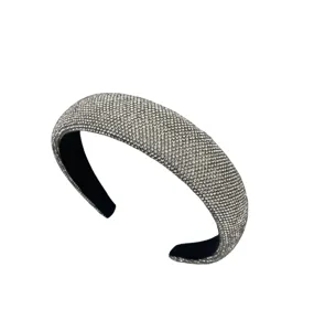 Detailed view of sparkling rhinestone padded headband, luxury crystal wide hair accessory.