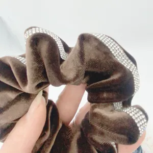 Brown velvet hair scrunchie with sparkling rhinestones, elegant ponytail holder accessory for women.