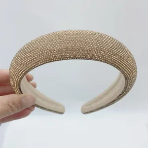 Close-up view of sparkling rhinestone padded headband, showing dense crystal details and sponge.