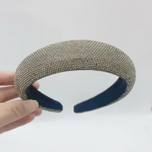Close-up of a luxury padded rhinestone headband, sparkling crystal hair hoop for women.