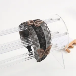 Detailed view of the black lace headband featuring embroidered brown butterflies and non-slip teeth.