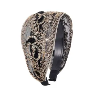 Elegant black mesh headband featuring intricate gold paisley embroidery and shimmering sequin details.
