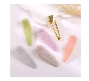 Close-up of candy color acrylic teardrop hair clips with metal duckbill clips, aesthetic.