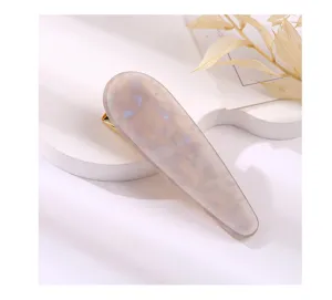 Elegant teardrop acrylic hair clip with marbled pattern and gold duckbill design for women.