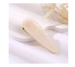 Acrylic teardrop hair clip detail view, elegant milky white finish for daily styling.