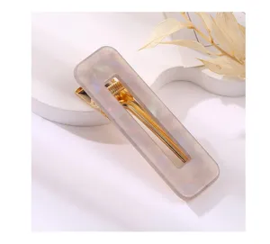 Minimalist rectangular acrylic hair clip with gold metal spring for elegant daily hairstyles.