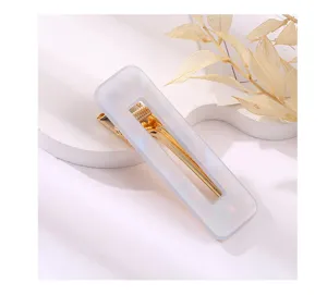 Close-up of a rectangular acrylic hair clip with a gold metal ducksbill design, elegant style.