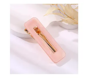 Pink acrylic rectangular hair clip detail view, featuring a sleek metal alligator clip base.