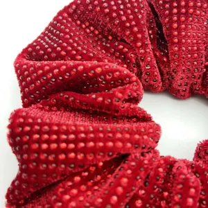 Close-up detail of red velvet rhinestone hair scrunchie, sparkling crystal chic hair accessory