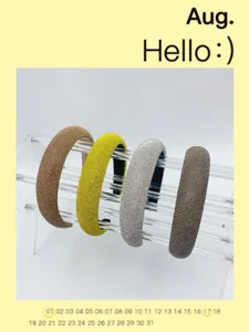 Detailed close-up view of sparkling rhinestone headbands displayed on a clear acrylic stand.