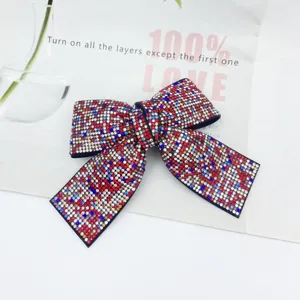 Close-up of sparkling colorful rhinestones embedded densely on elegant bow texture