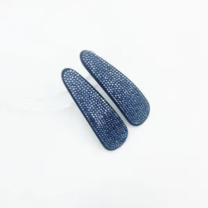 Sparkling dark blue rhinestone snap hair clip detail, close up view of crystal hairpin.