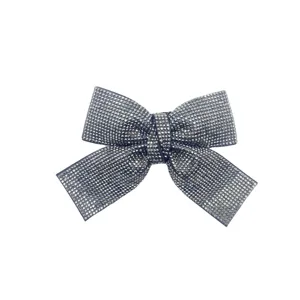 Sparkling rhinestone bow hair clip, crystal paved hairpin detail, elegant hair accessory.