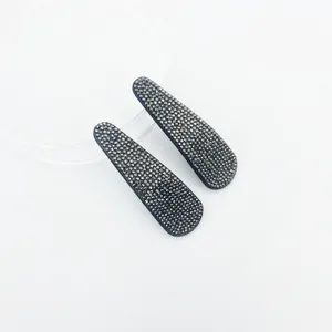 Close-up details of sparkling rhinestone snap hair clips with dense dark crystals for daily wear.